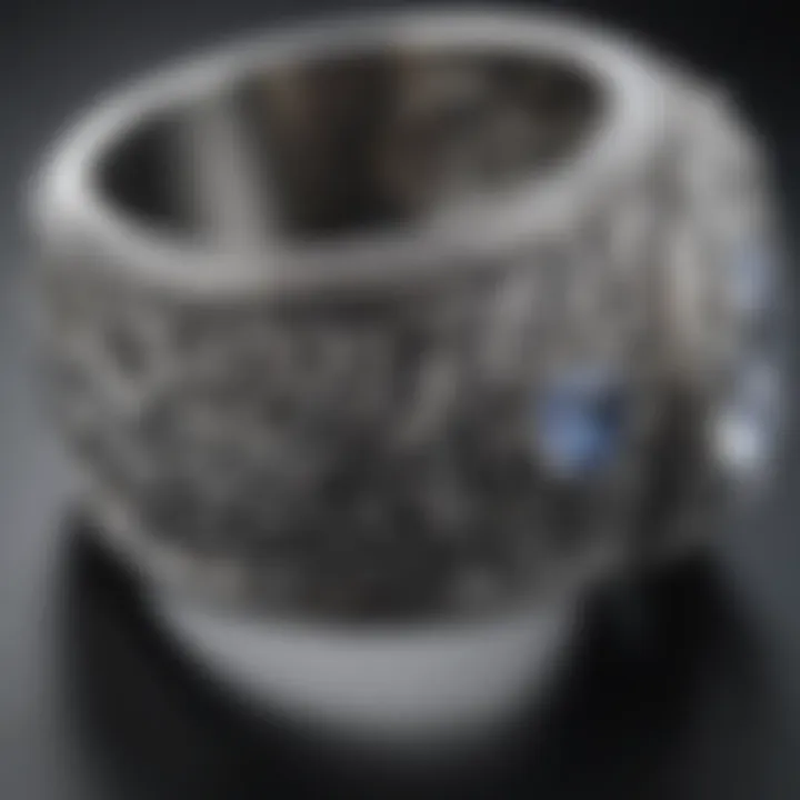 A close-up of a silver ring with intricate designs.