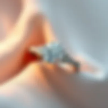 A close-up view of a sparkling diamond engagement ring on a soft fabric background