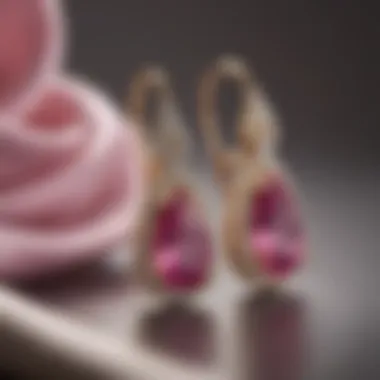 Elegant pink sapphire earrings on a soft fabric background, emphasizing their luxurious design.