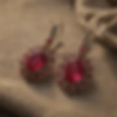 A beautiful display of various African ruby earrings laid against a textured fabric background