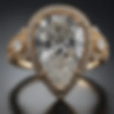 Close-up of a pear diamond ring delicately set in intricate jewelry.