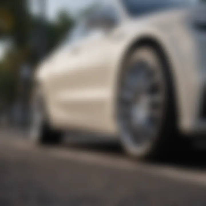 Luxury Vehicle Showcasing White Diamond Rims on Road